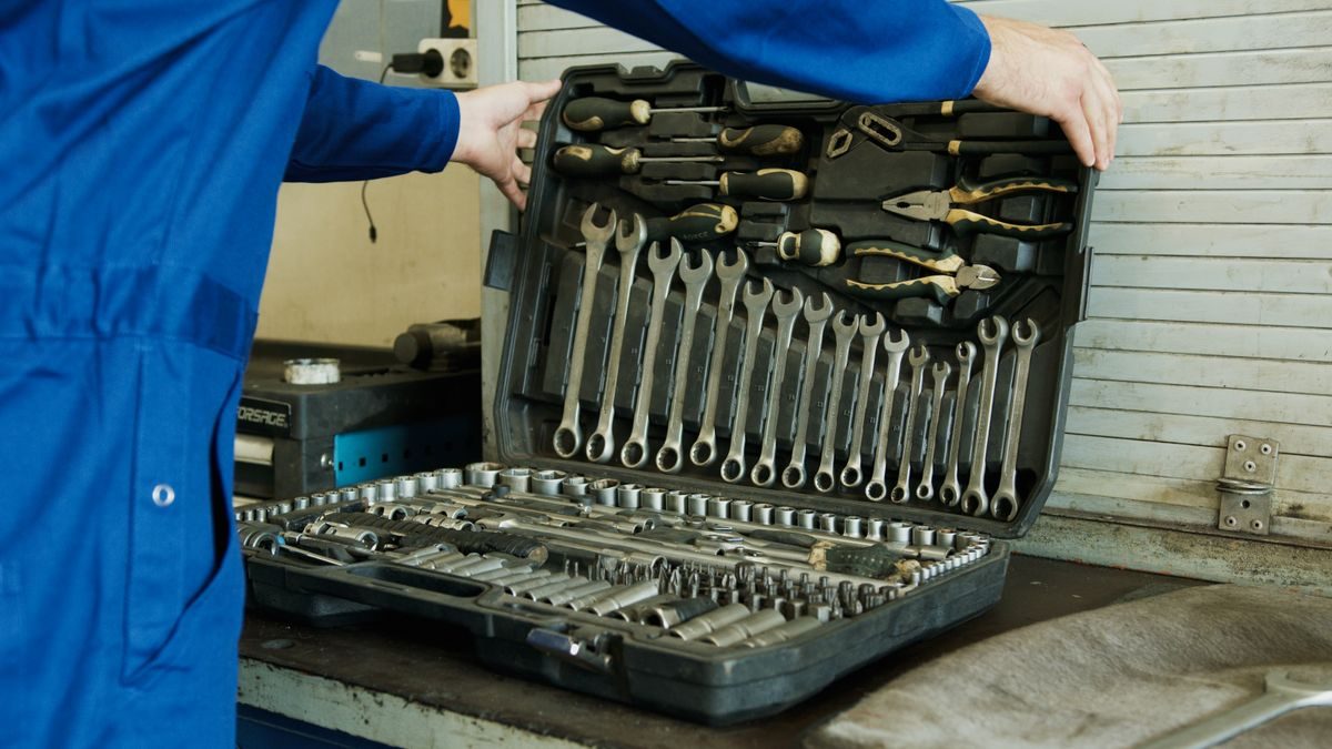 An open case of spanners and sockets on a workbench.